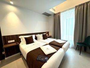 a hotel room with two beds and a chair at Hotel Kavia Sarria in Sarria +88 photos