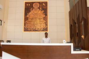 a man standing behind a counter in a room at YC Grand Mystic Premier, Electronic City in Bangalore