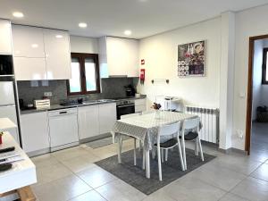 a kitchen with a table and chairs in a room at Casa da Laija - Vistas rio - "Gerês" in Geres