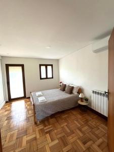 a bedroom with a bed and a wooden floor at Casa da Laija - Vistas rio - "Gerês" in Geres +58 photos