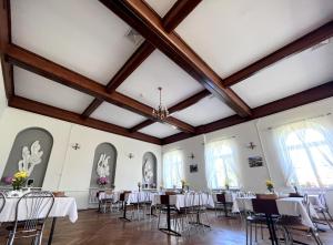 a banquet hall with white tables and chairs at Łazienki Uzdrowiskowe Nr 1 in Ciechocinek