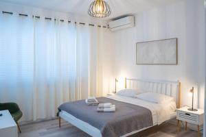 a bedroom with a bed with two towels on it at Pansion Marinka-Bire Rooms in Lumbarda