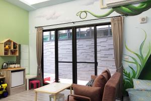 a living room with a sliding glass door at 維邇莊園-Weir manor 傑克堡 in Tainan