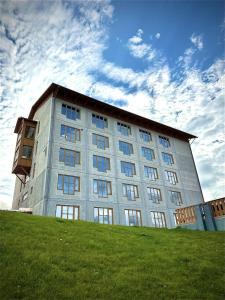 a large building on top of a grassy hill at Saxnäsgården Hotell in Saxnäs