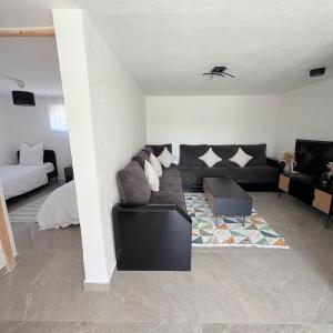 a living room with a couch and a bed at Lumière du paradis in Villes-sur-Auzon