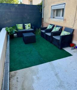 a patio with two couches and a green lawn at Lumière du paradis in Villes-sur-Auzon