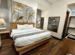 a bedroom with a bed with a painting on the wall at Paradise Boutique Stays in Solan