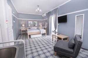 a room with a bedroom with a bed and a couch at Retro luxury rooms in Olympic Beach