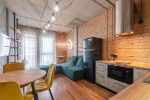 a kitchen and a living room with a couch and a table at 3-217 Rybalsky, Naberezhno Rybalska 3, Kyiv centre, panoramic city view, 15 kW backup power, Petrovdom Apartment in Kyiv