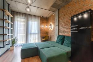 a living room with a couch and a brick wall at 3-217 Rybalsky, Naberezhno Rybalska 3, Kyiv centre, panoramic city view, 15 kW backup power, Petrovdom Apartment in Kyiv