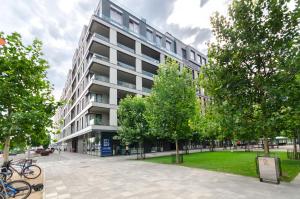 a large apartment building with trees in front of it at 3-217 Rybalsky, Naberezhno Rybalska 3, Kyiv centre, panoramic city view, 15 kW backup power, Petrovdom Apartment in Kyiv