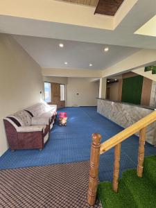 a large living room with a couch and a staircase at Ostal Residency Pangong in Meruk