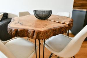 a table made out of a tree stump with a bowl on top at MOLO LIPNO RESIDENCE in Lipno nad Vltavou