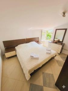 a bedroom with a bed with two towels on it at Nikita Lux in Lagadin