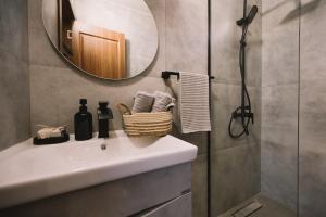 a bathroom with a white sink and a mirror at Casa Arte 2 in Ulcinj +10 photos