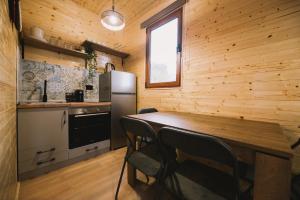 a kitchen with a table and a refrigerator at Casa Arte 2 in Ulcinj