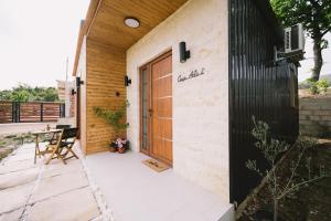 a patio with a wooden door and a table at Casa Arte 2 in Ulcinj