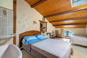 a bedroom with a bed and a sink and a tub at Chambre d'hôtes La Champagne in Sémussac +67 photos