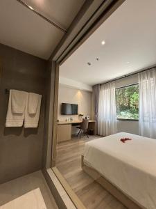 a bedroom with a bed and a desk and a window at The Luxe Da Lat in Da Lat +132 photos