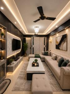 a living room with a couch and a tv at Dream Residency in Karnal