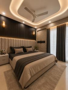 a bedroom with a large bed with a ceiling at Dream Residency in Karnal