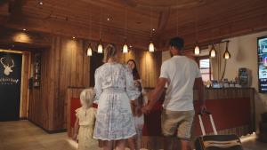 a man and a woman and a child holding hands at Hotel Schörhof in Saalfelden am Steinernen Meer +68 photos