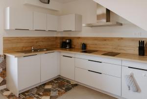 a kitchen with white cabinets and a sink at Villa de Meslay in Montaigu-Vendée