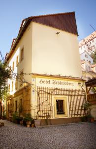 a building with a sign on the side of it at Hotel Schlossberg in Meißen