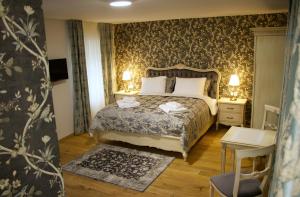 a bedroom with a bed with two towels on it at Hotel Schlossberg in Meißen