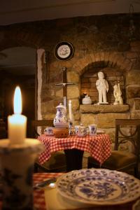 a table with a tea set with a candle on it at Hotel Schlossberg in Meißen