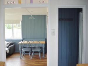 a dining room with a table and chairs at Hydaway in Bacton