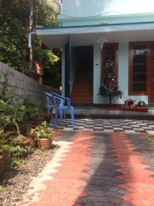 a house with a christmas tree on the porch at Cherish homestay in Cochin