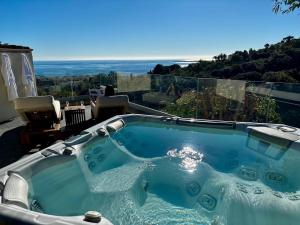 a hot tub on a patio with a view at Sea View Villa Roc d'Azur - Pool - Jacuzzi in Vallauris