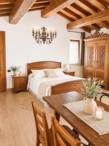 a bedroom with a bed and a dining room table at Il Castelletto di Gomo - Relax nella natura con SPA privata outdoor in Godiasco