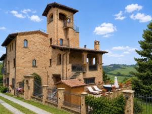 an old building with a tower on top of it at Il Castelletto di Gomo - Relax nella natura con SPA privata outdoor in Godiasco