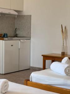 a room with two beds and a kitchen with a counter at Kofini Falassarna in Falasarna +45 photos