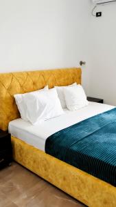 a bedroom with a large bed with a wooden headboard at Hotel Corali in (( Spile ))