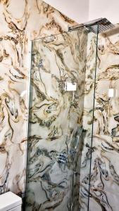 a shower in a bathroom with a marble wall at Hotel Corali in (( Spile )) +59 photos