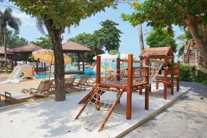 a group of chairs sitting next to a pool at Kacha Resort & Spa, Koh Chang in Ko Chang
