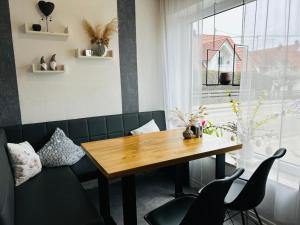 a dining room with a wooden table and chairs at Pension Merkle in Ichenhausen
