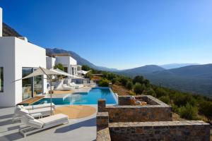 a view of a villa with a swimming pool at Luxury Villa with Panoramic Sea Views in Thólos
