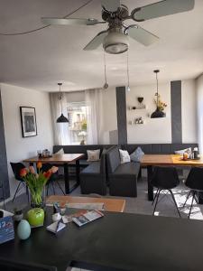 a living room with a couch and a ceiling fan at Pension Merkle in Ichenhausen