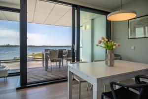 a dining room with a view of the ocean at Veerse Muze in Kamperland