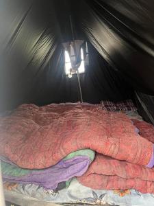 a large bed in a tent with a light at The Kedar Stay in Kedārnāth +15 photos