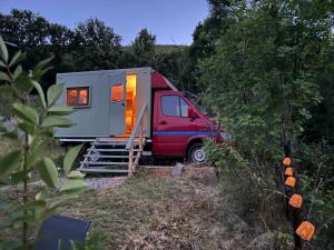 a red van parked in front of a tiny house at Villa Lugina in Fushë-Buall