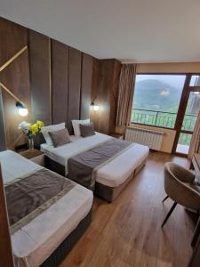 a hotel room with two beds and a large window at Lucky Hotel in Veliko Tŭrnovo +90 photos