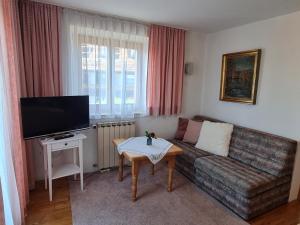 a living room with a couch and a table at Gästehaus Radlerhof in Gstadt am Chiemsee