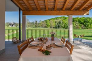 a table on a patio with a view of a yard at Albergo Diffuso Forgaria Monte Prat in Forgaria nel Friuli