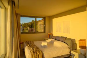 a bedroom with a bed with two towels on it at Luxury Villa with Panoramic Sea Views in Thólos +48 photos