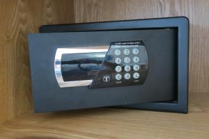 a small television with a remote control in it at Central Hotel in Saint-Denis